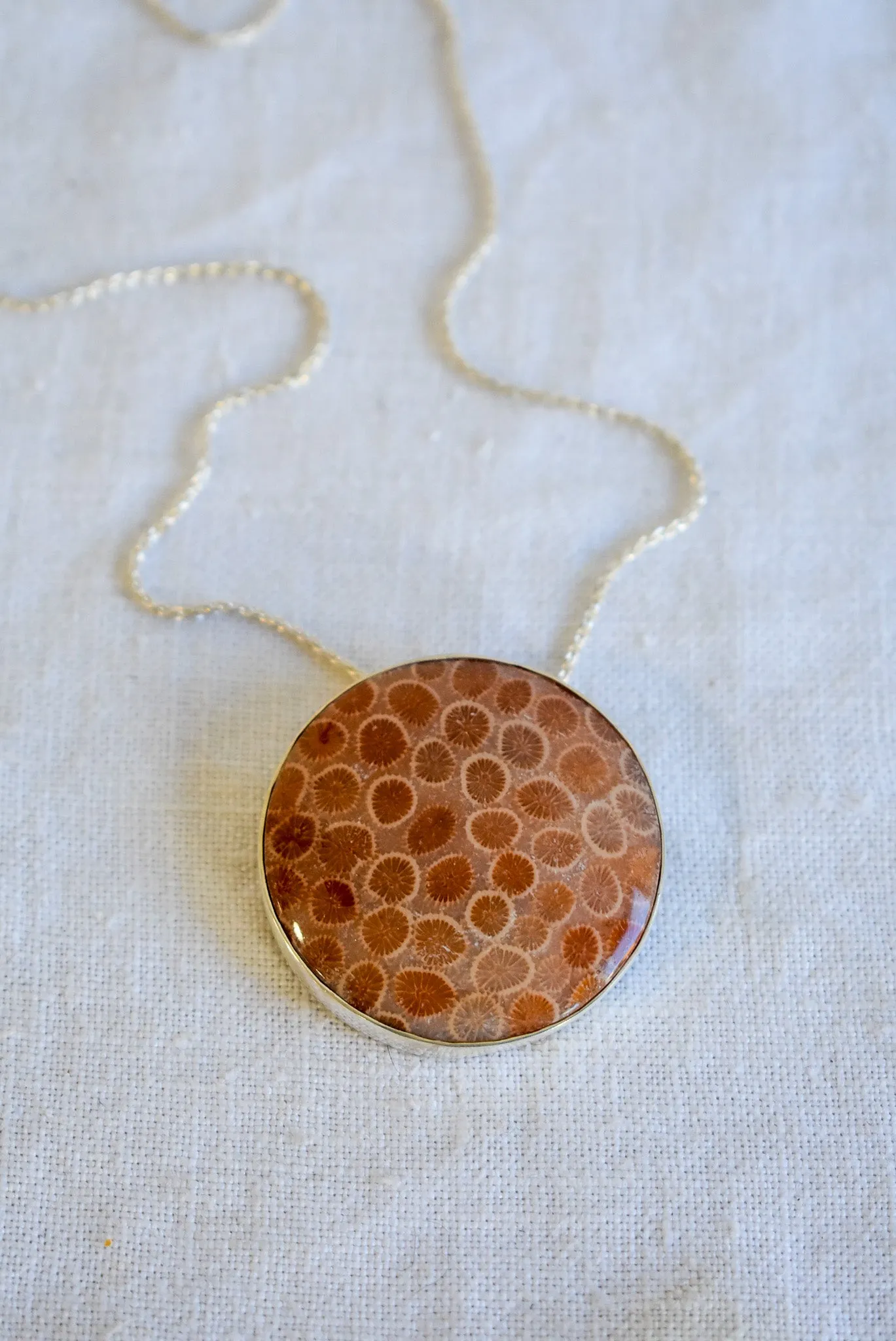 Fossilized coral set in silver snake chain necklace