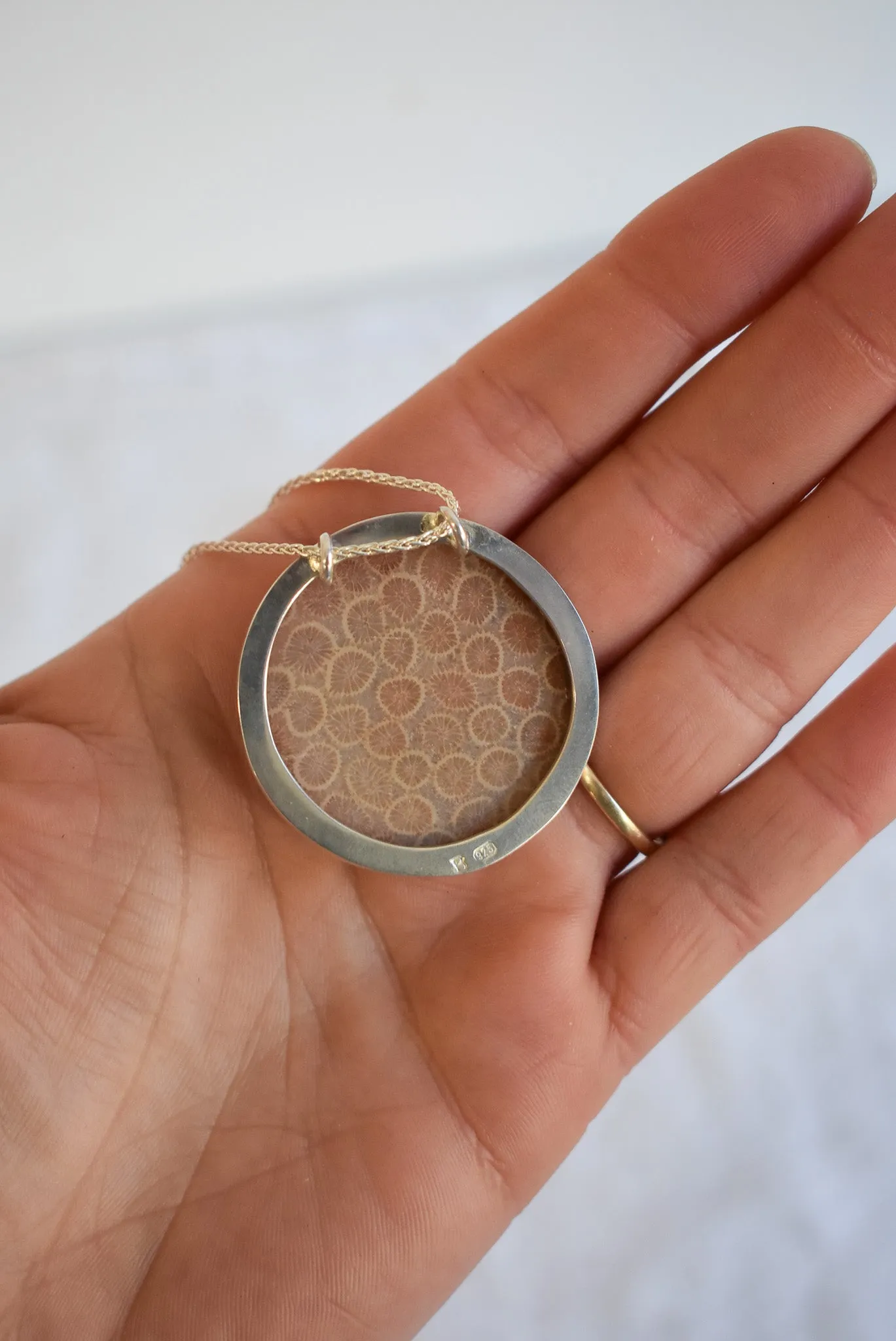 Fossilized coral set in silver snake chain necklace
